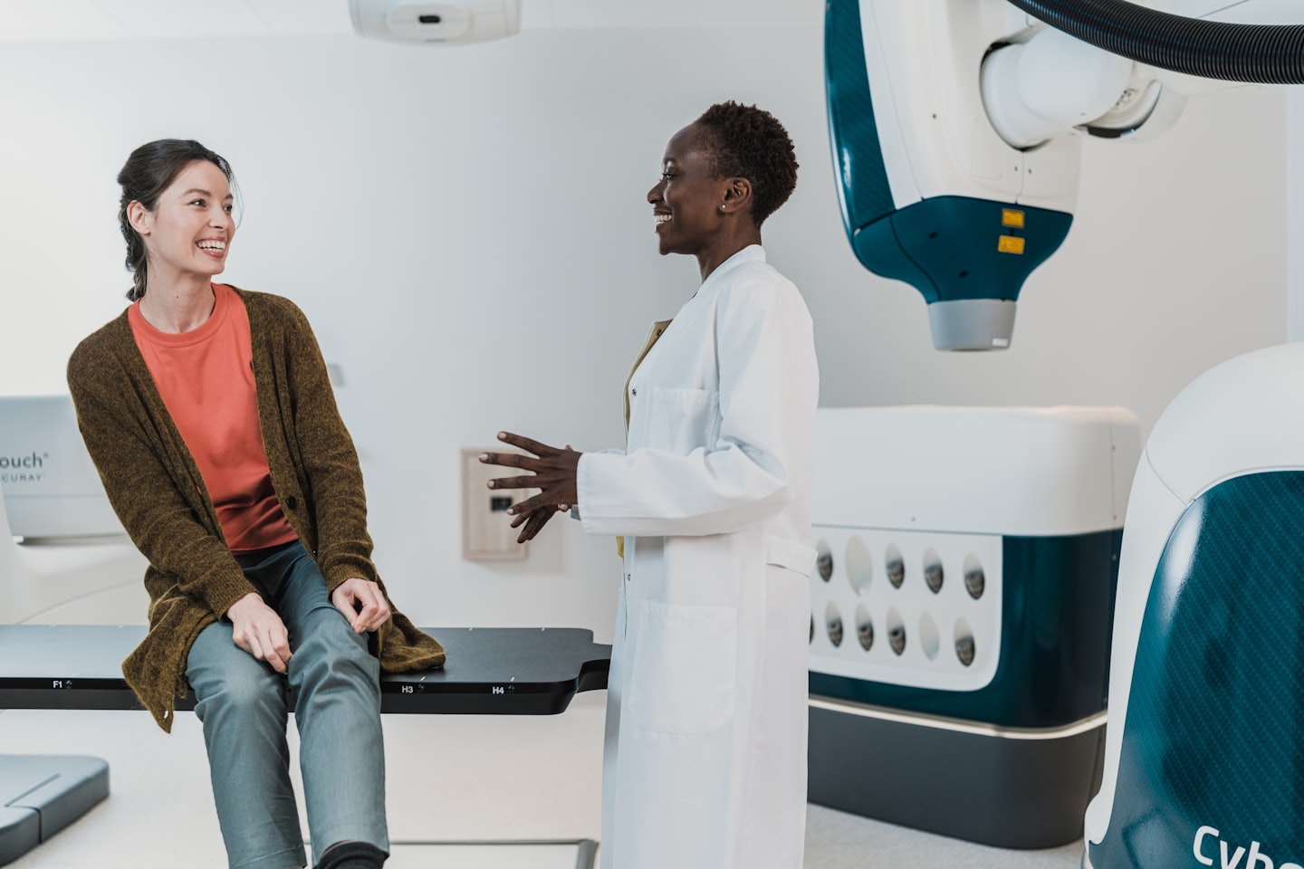 Medical professional discusses with patient in a clinic.
